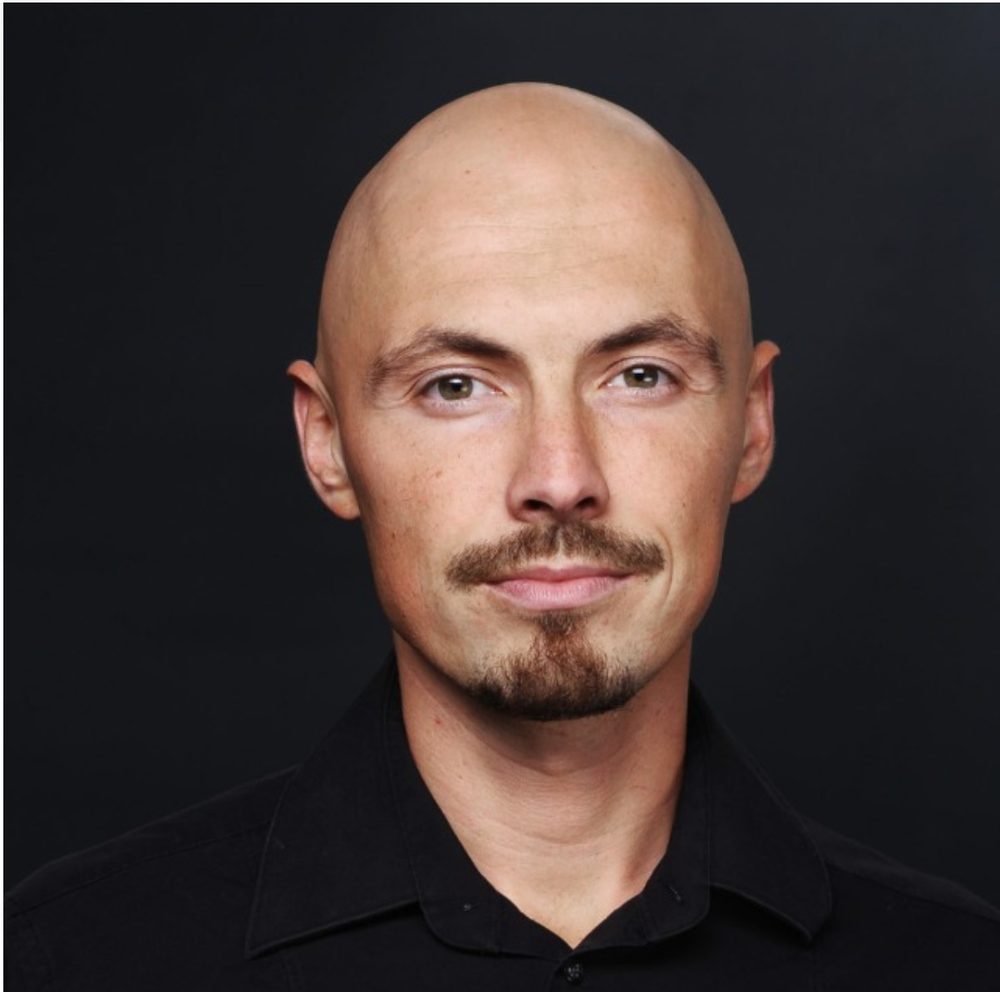 Portrait of Janis Berzins on a black background