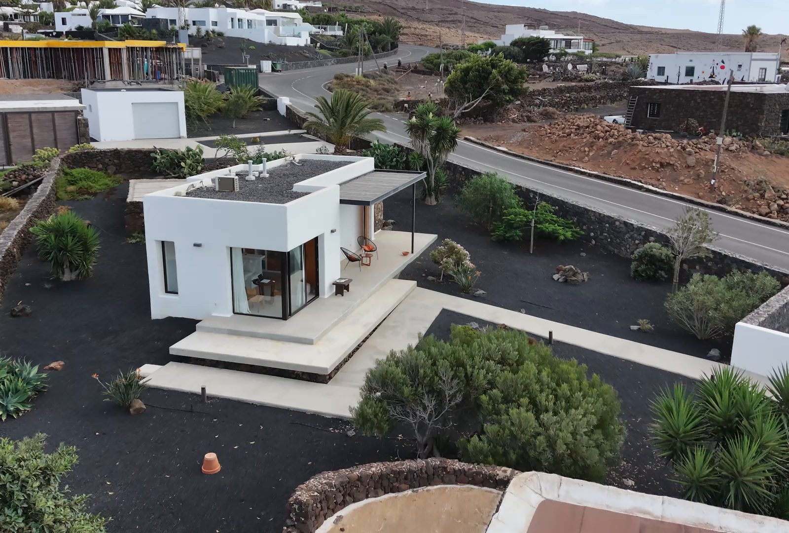 A white holiday house with a terrace among volcanic gardens on Lanzarote